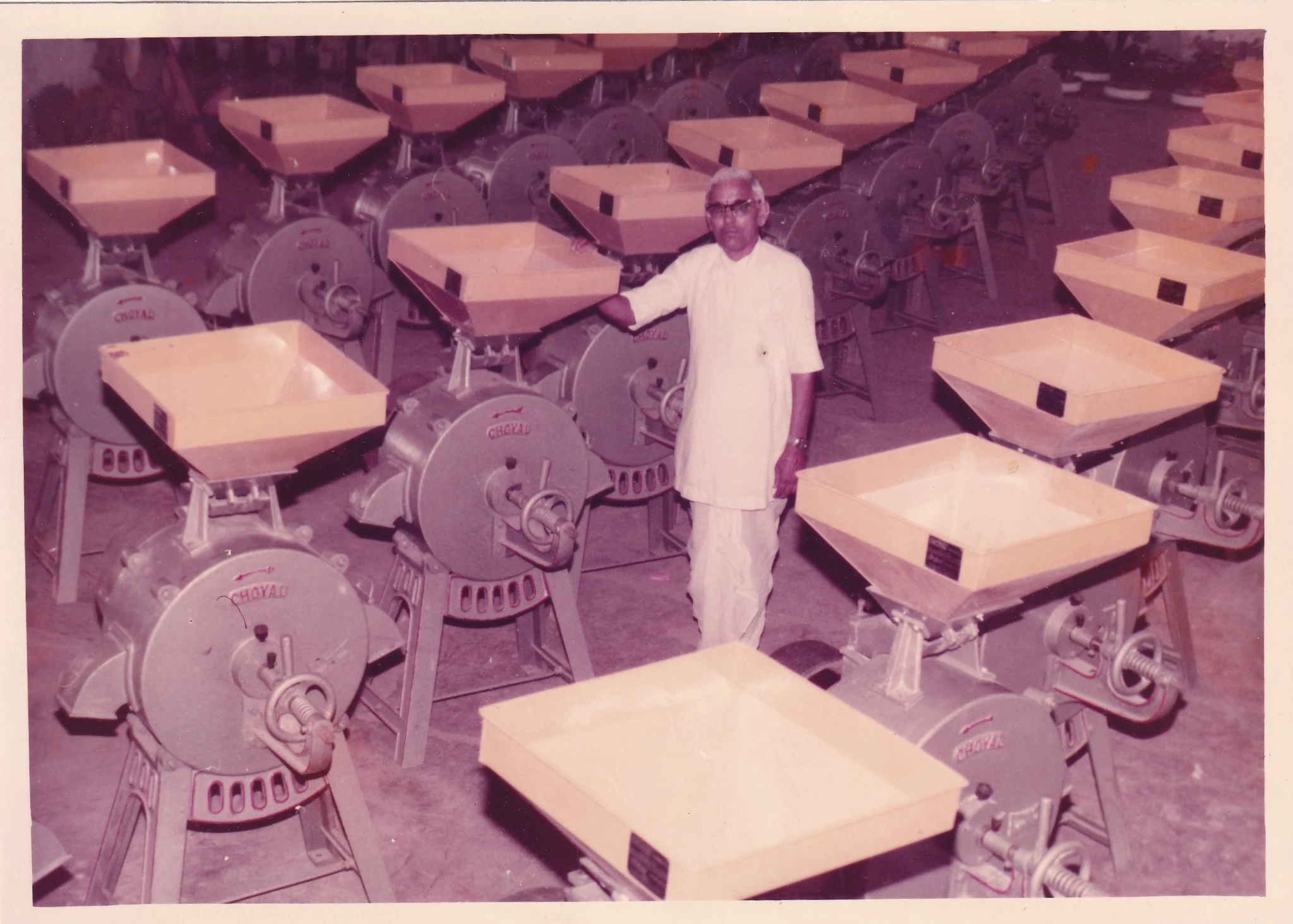An archival photograph of Choyal’s founder amongst flour mills